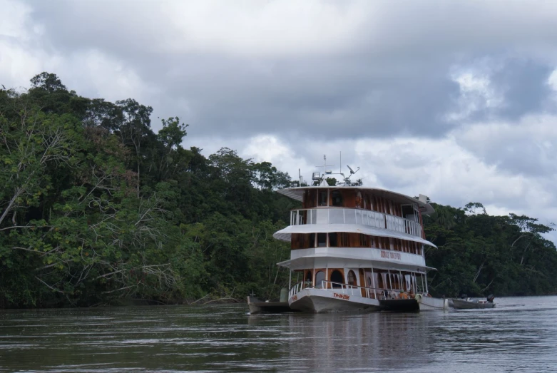 a boat is floating on the water and surrounded by trees