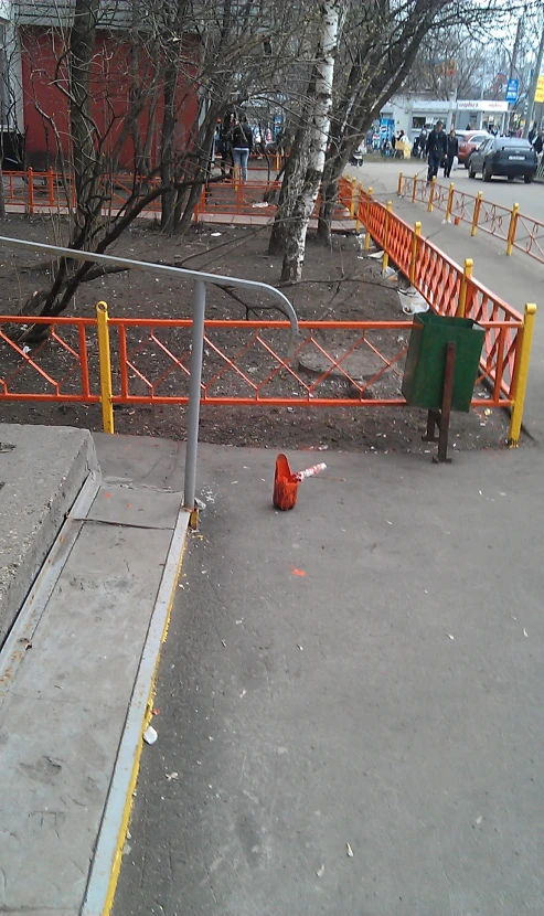 a yellow barricade sits on the side of a city road