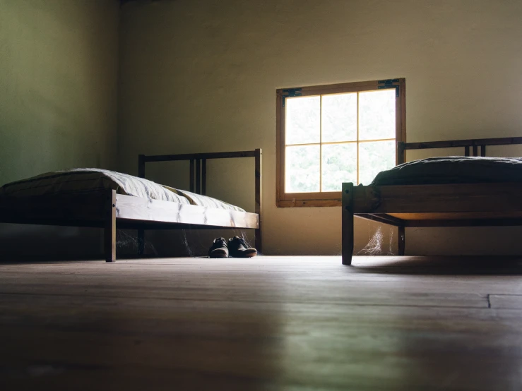 a bed room with two beds and a window