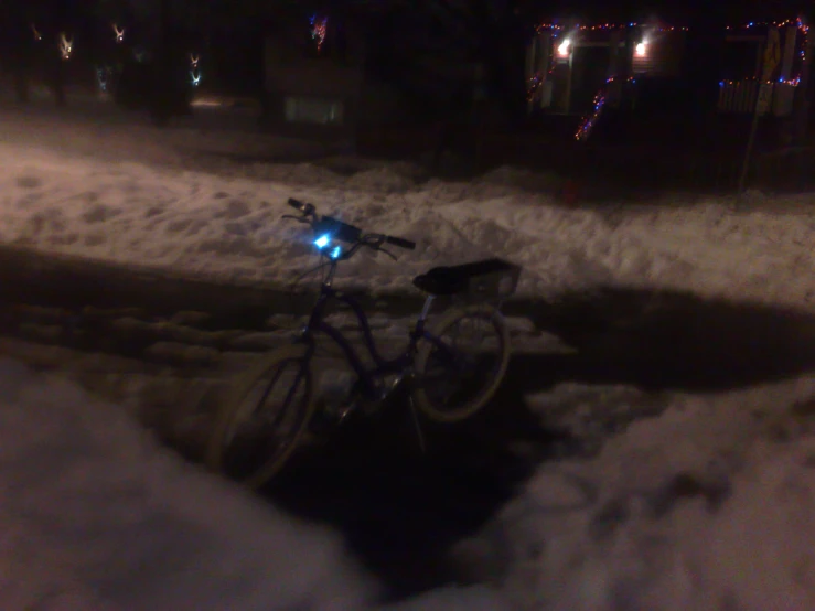 a bike in the snow under some lights