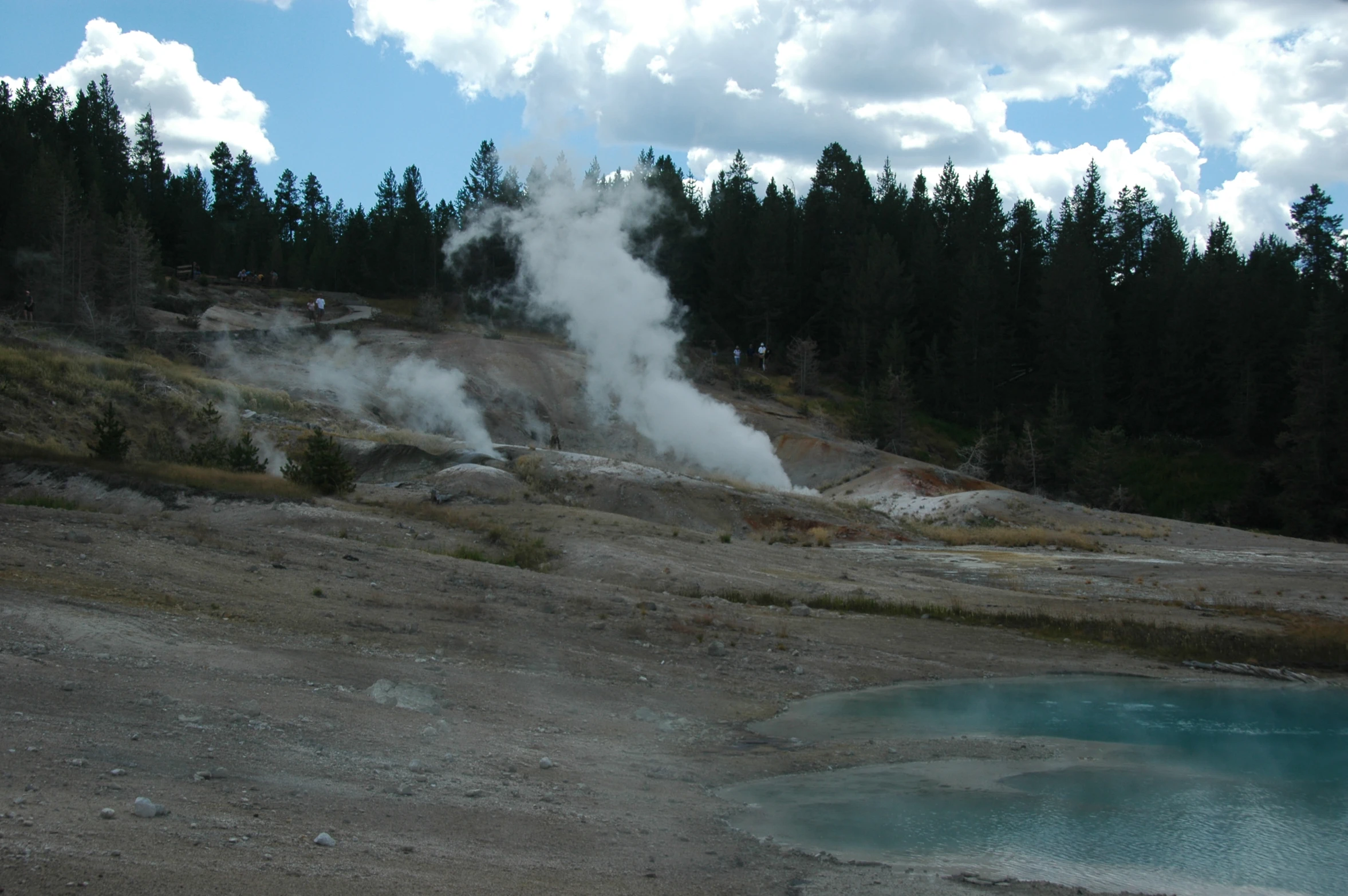 a large steam plume in the middle of a small lake