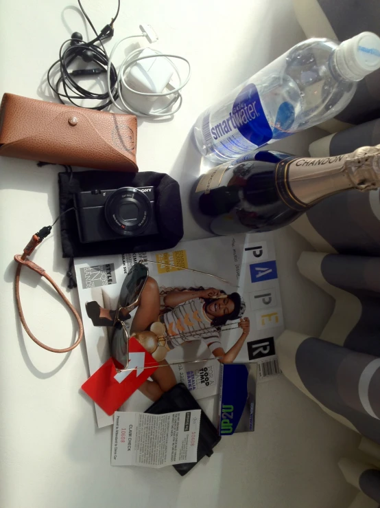 a camera sitting on top of a table next to various items