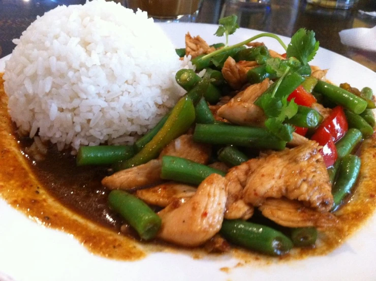 plate with stir fried vegetables and meat and rice on it