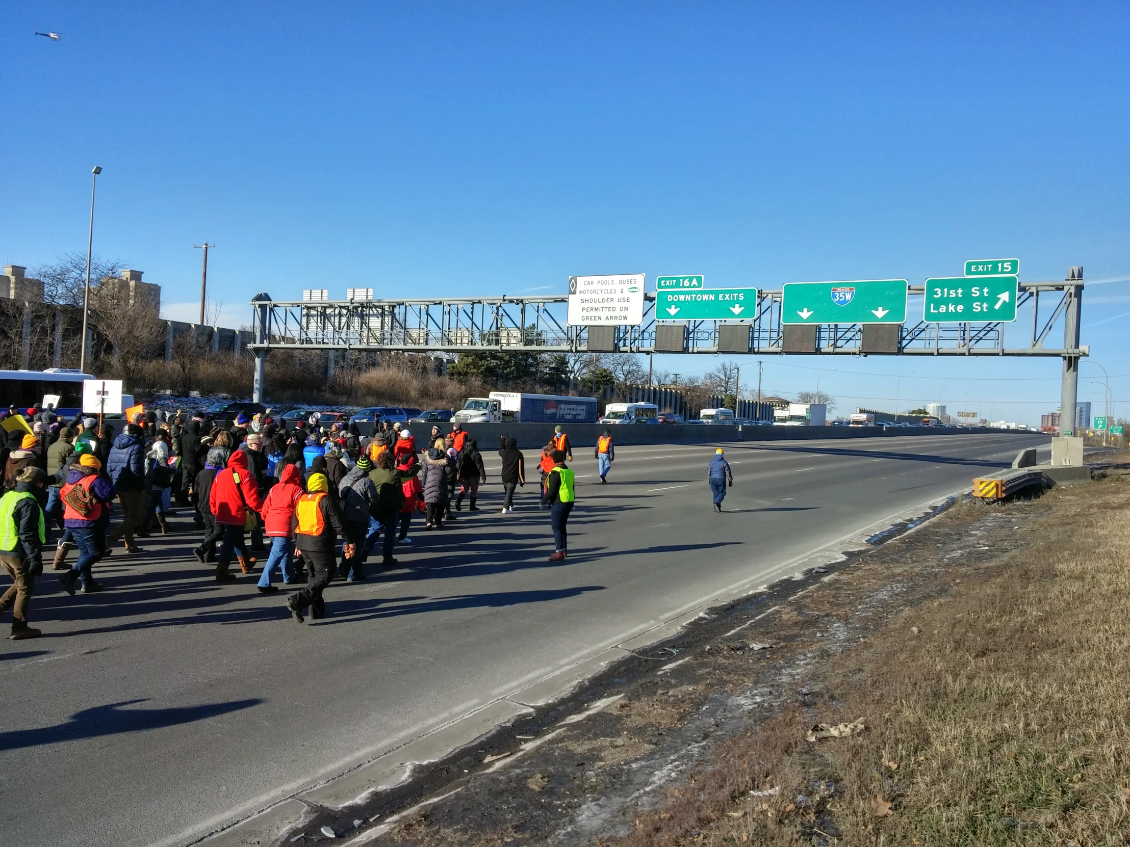 a bunch of people that are walking on a road