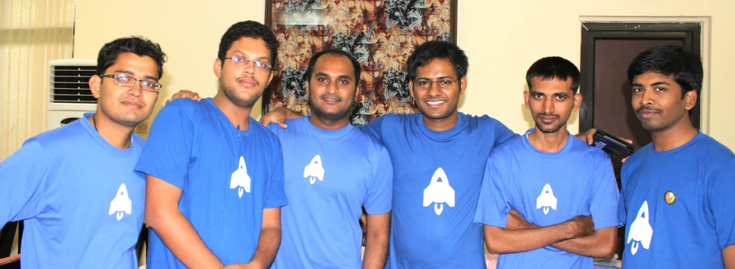 group of indian guys in shirts holding up a peace sign