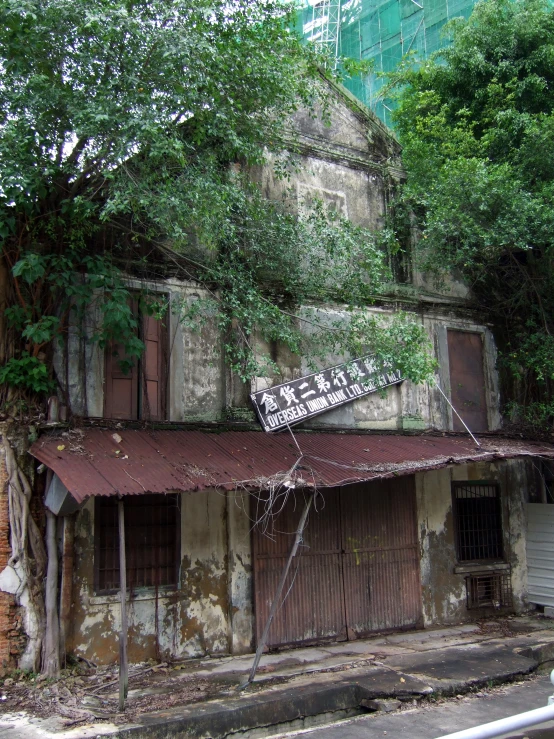 a rundown building sits on the side of the street
