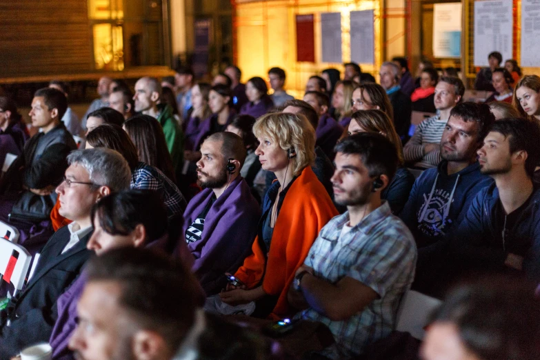 a crowd is in a room of people waiting