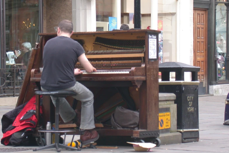 a man is sitting at an old piano