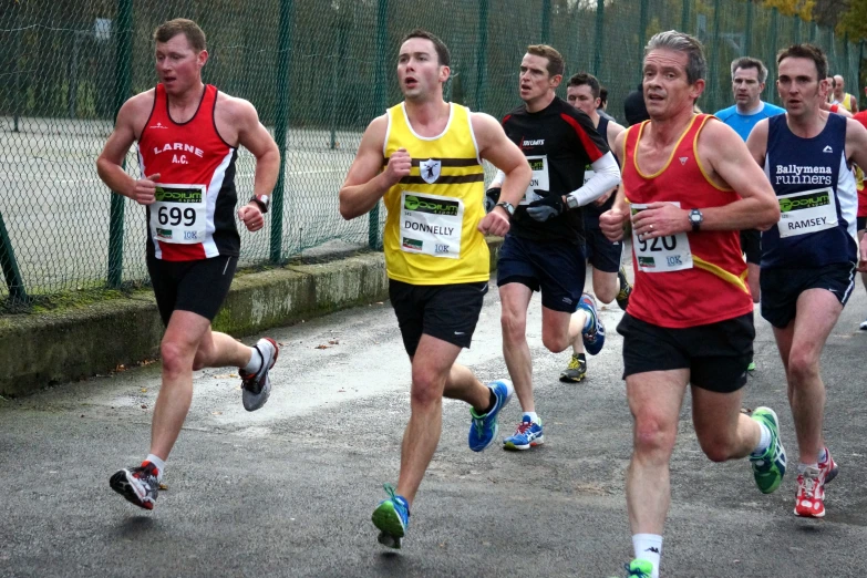 a group of men running together on a track