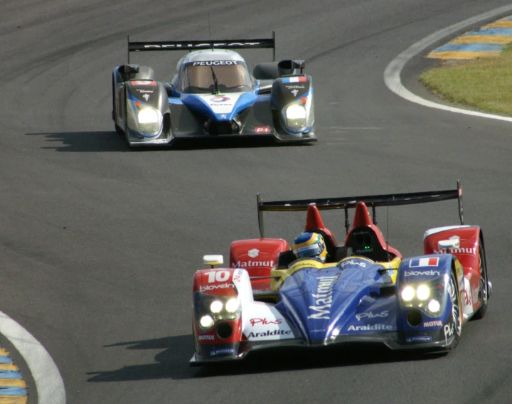 two race cars are driving on a race track