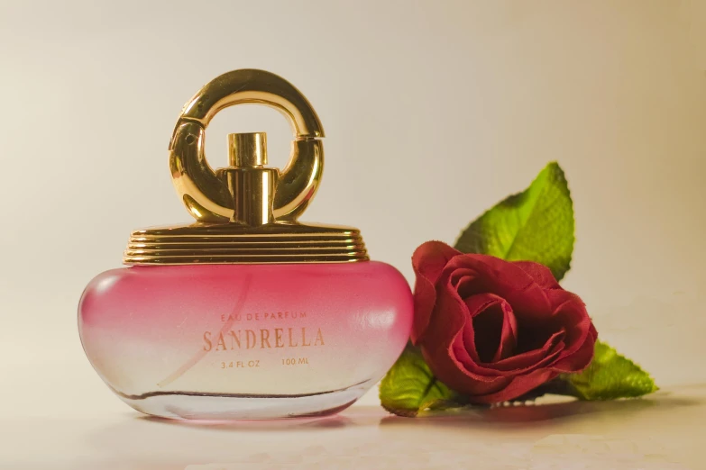 perfume bottle with red rose and golden handle