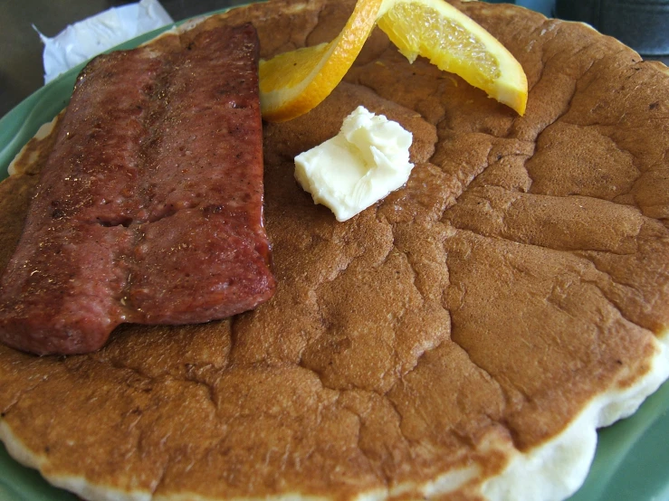 a pancake with meat and er on it