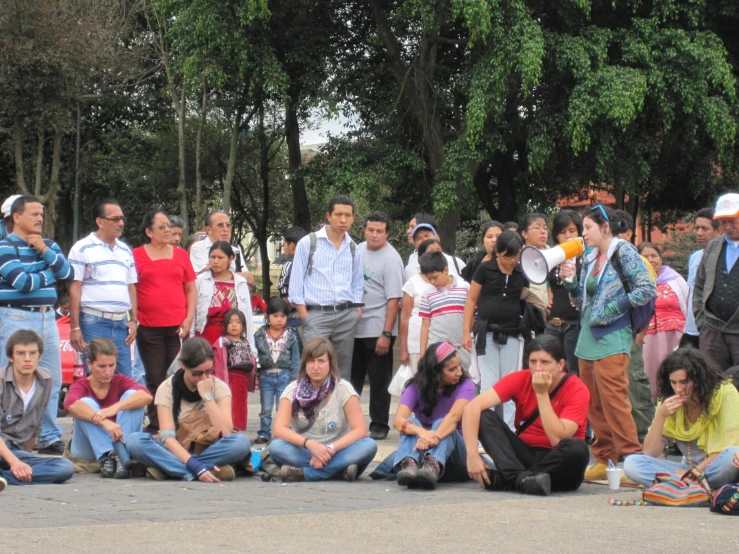 a group of people standing in a circle and sitting down