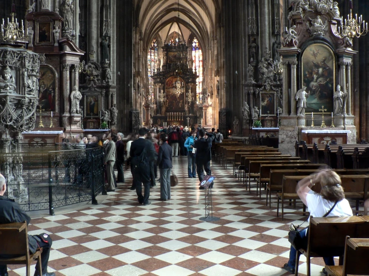 some people sitting in chairs at a large church