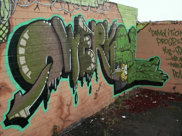 a brick wall covered in graffitti with graffiti