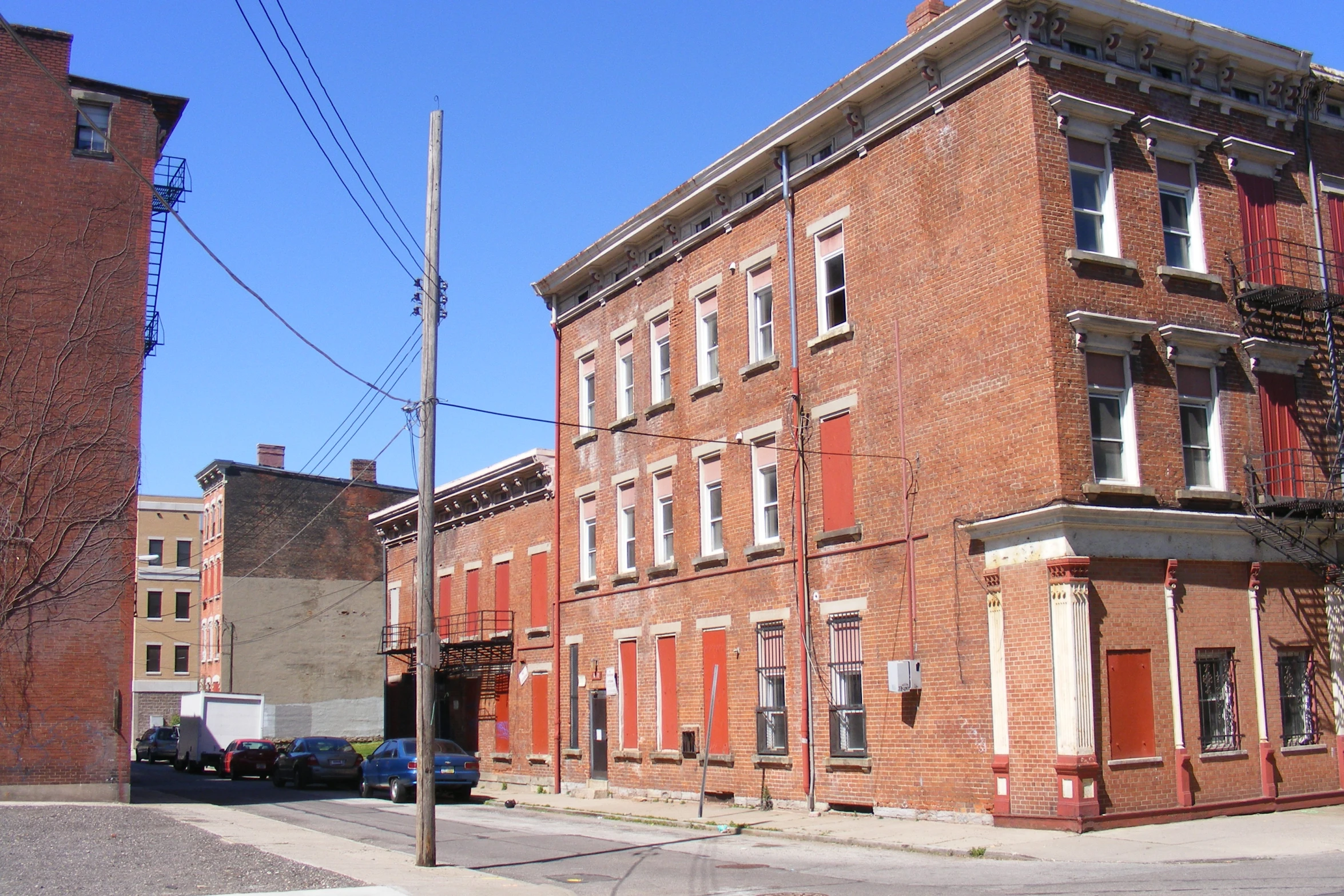 a city block with many windows and some red shutters