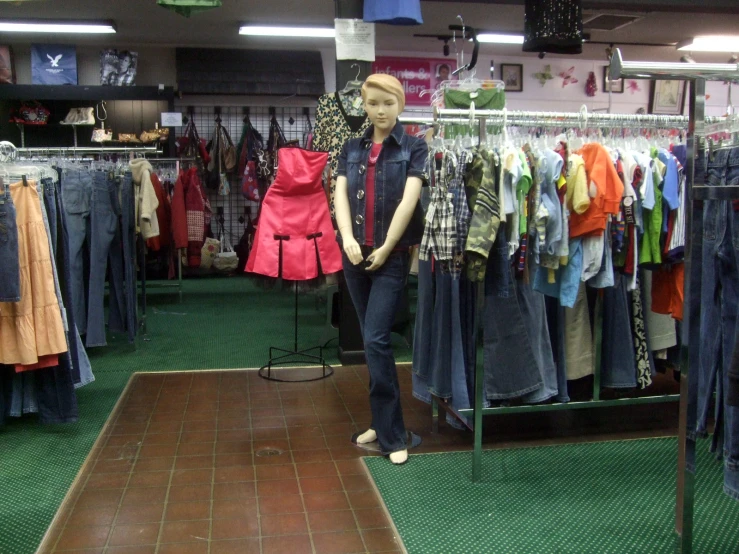 a mannequin is standing in front of a rack of clothing