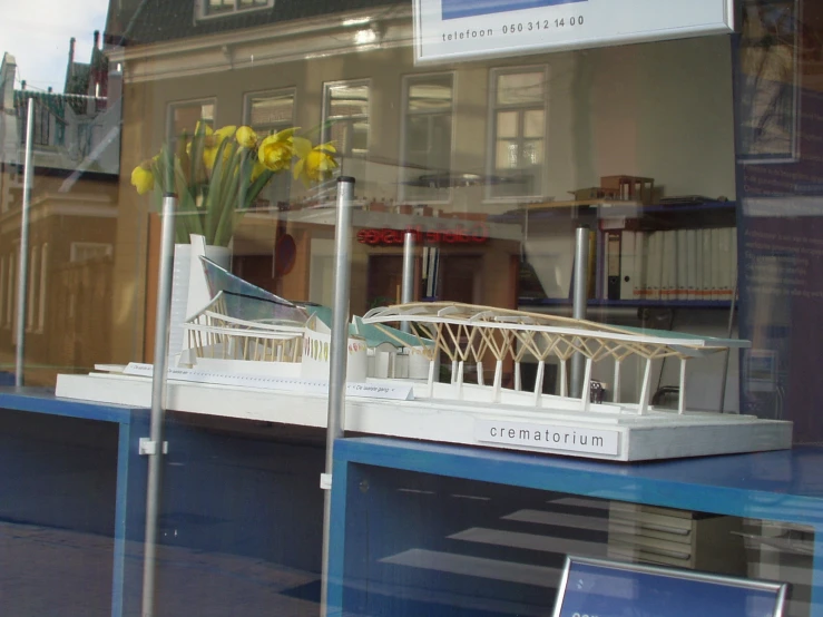 a display case in a store with flowers inside of it