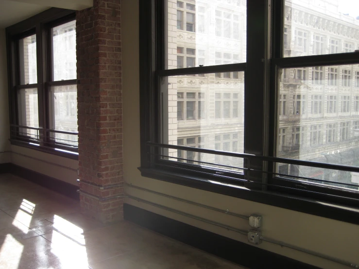 a room with large windows and a tiled floor