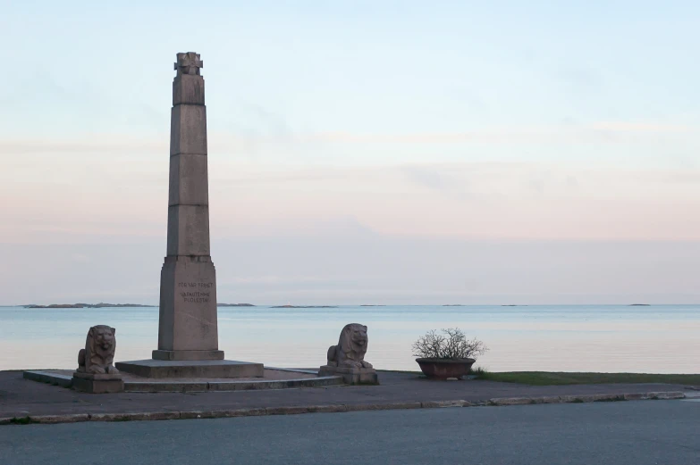 a view of the ocean next to a monument