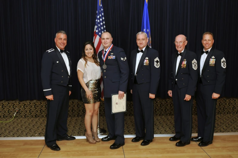 a group of people standing next to each other in uniforms