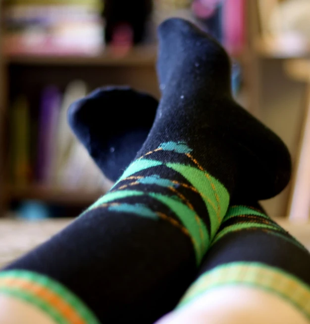 a person's legs in green striped socks