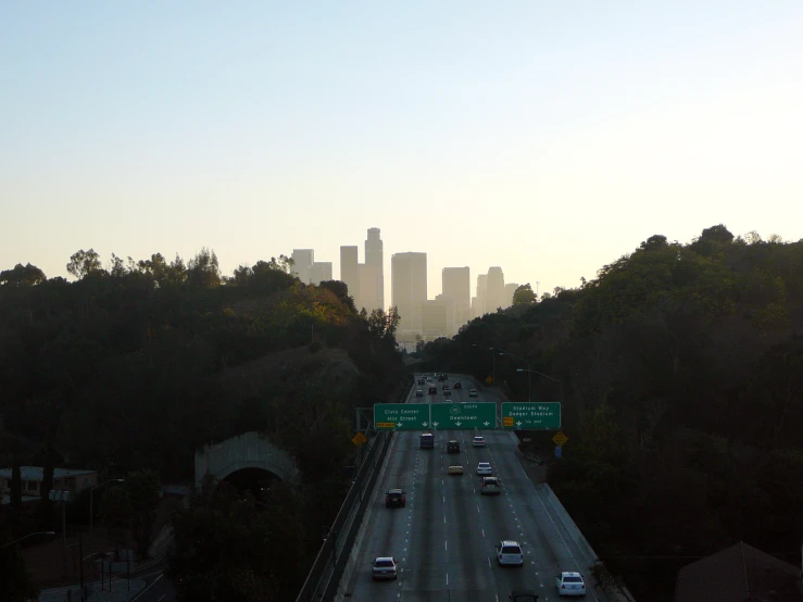 an interstate and freeway freeway with city skyline in the background