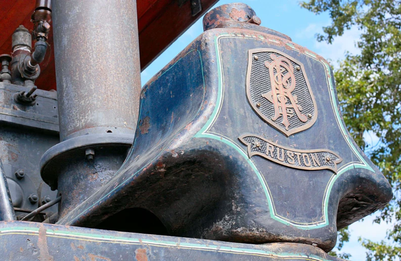 an old locomotive with two large, silver emblems