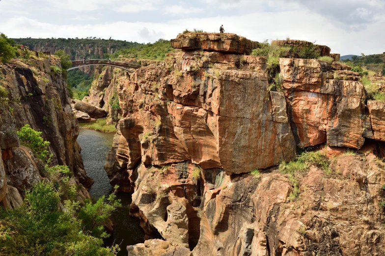 a big rock outcropping next to a river