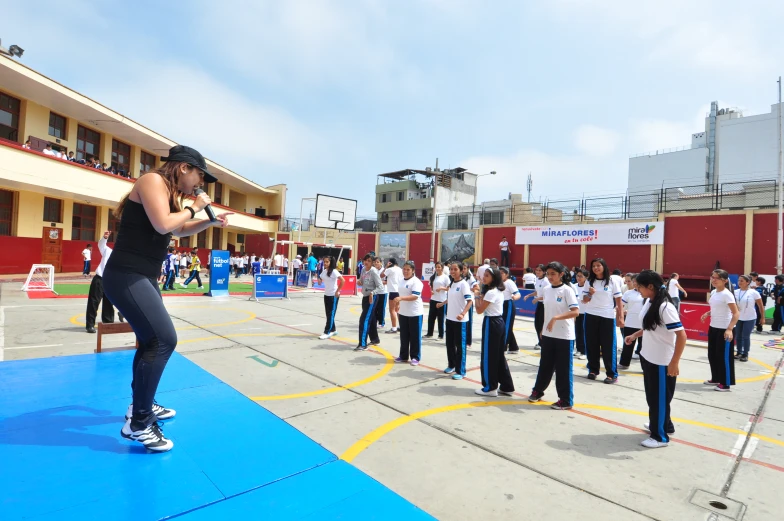 a group of people in white shirts and blue shorts