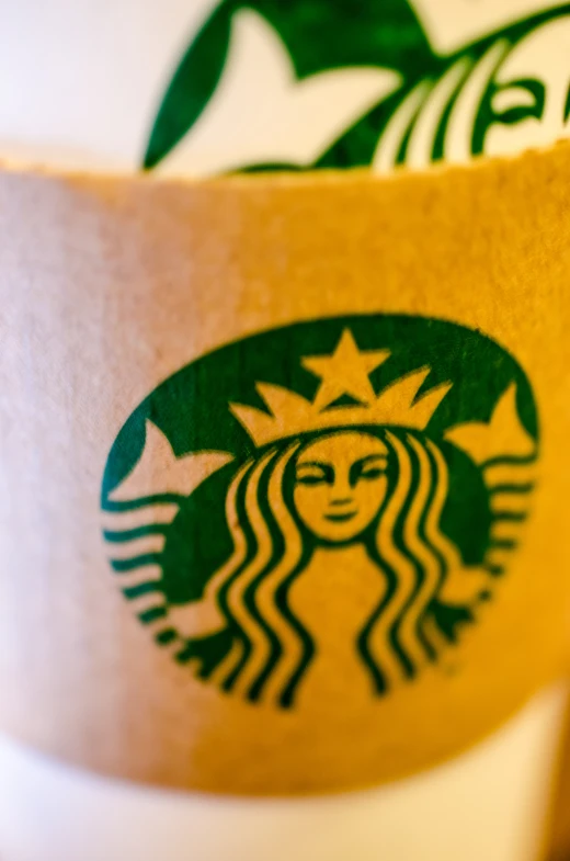a coffee cup with a starbucks logo is seen here