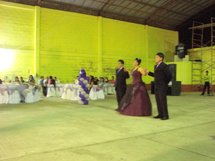 a bride and groom dance in front of an audience