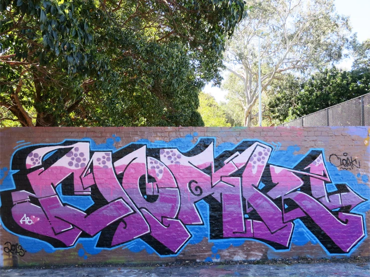 the graffiti wall is painted bright purple, and black