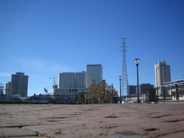 an old brick street with a few tall buildings in the background