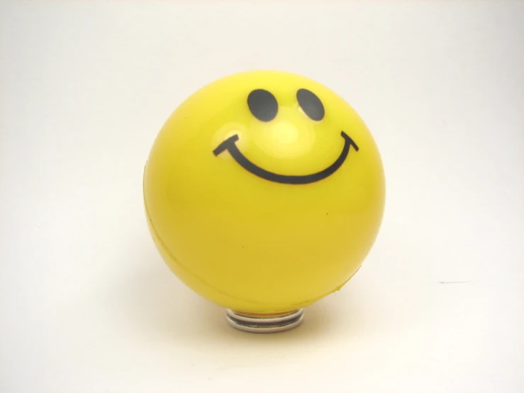 there is a yellow sphere with a happy face on it