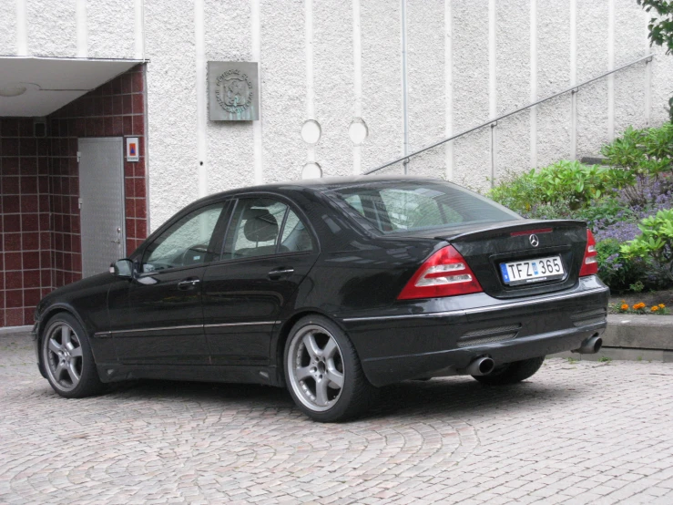 a black car parked in front of a building