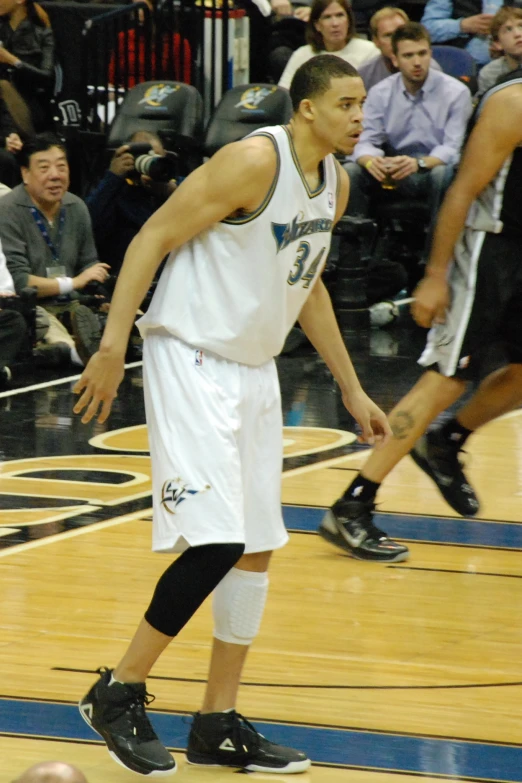 a man that is standing on a court with a basketball