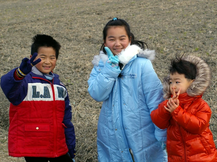 two s and a girl are posing for the camera