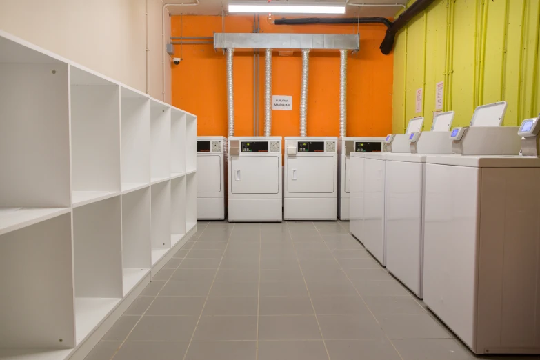 a line of industrial laundry sinks in the hallway of a facility