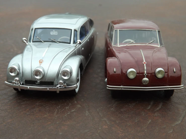 a close up of two miniature cars on a table