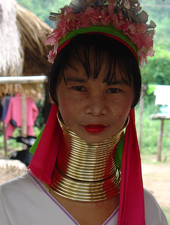 woman wearing a gold neck piece around her neck