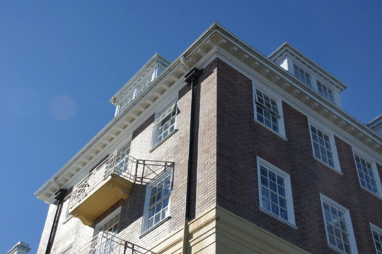 a tall brick building that has white windows