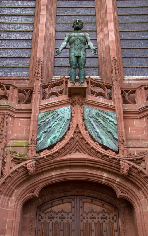 a door of a building has statues above the door