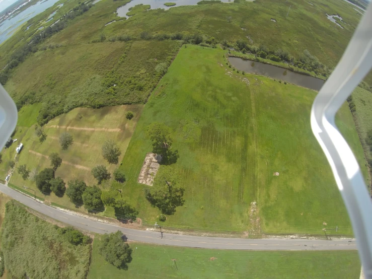 an aerial s of a grass field and river