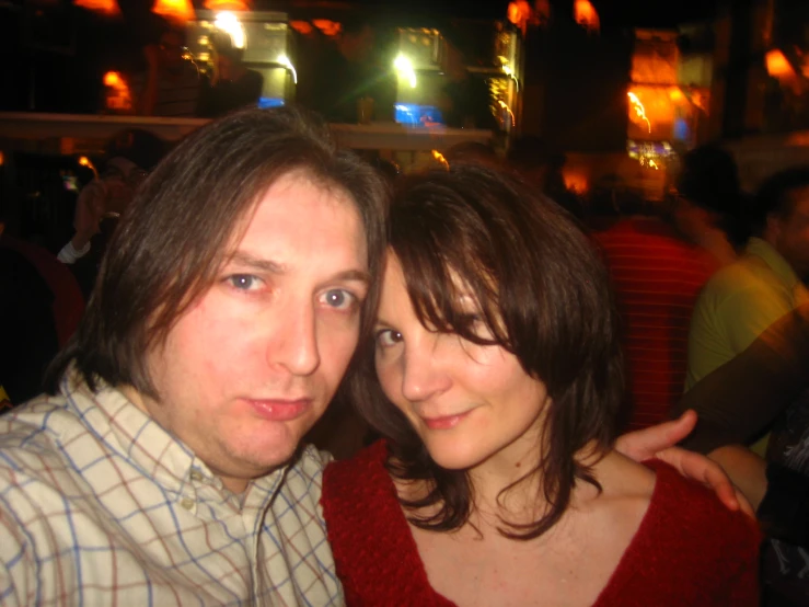 man and woman taking a picture at night club