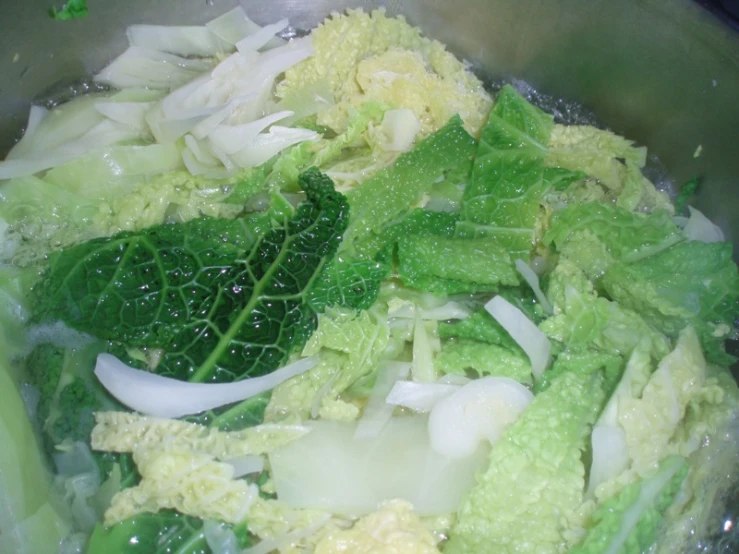 a vegetable salad being cooked in a wok