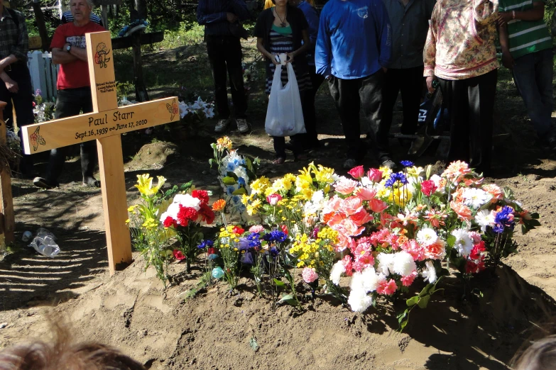 an elaborate display of flowers sits at the end of a flowerbed