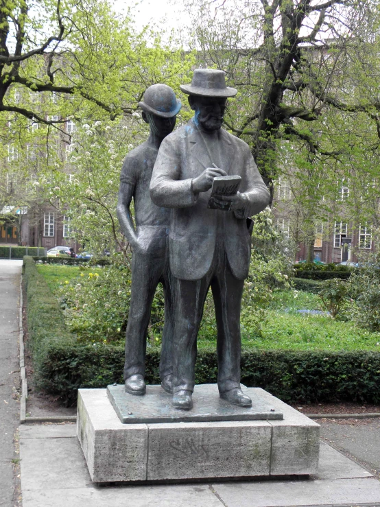 the statues of men stand in front of a building