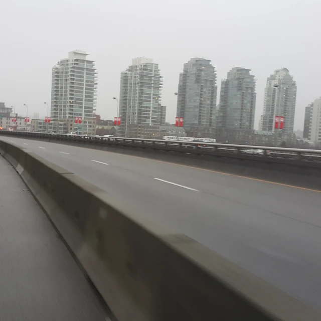 a street with a highway sign and cars on it