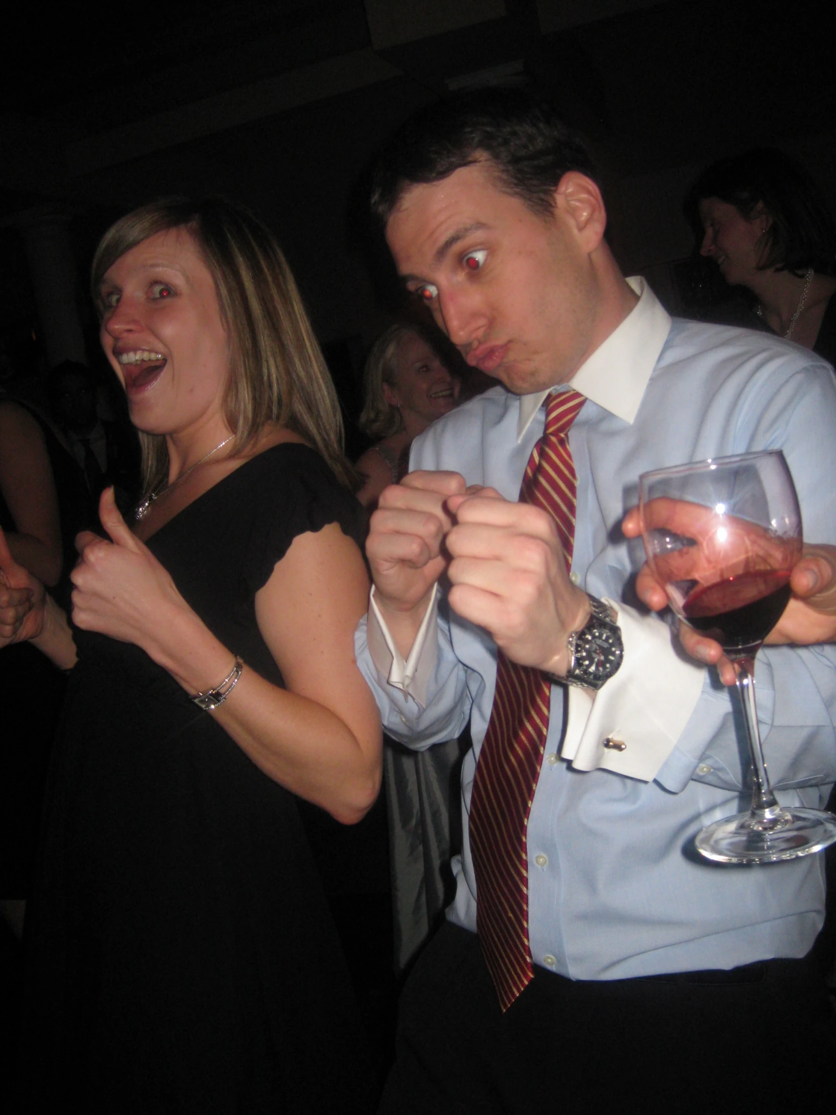 two people in the foreground have wine glasses and one has a red drink